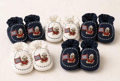 a group of baby shoes with teddy bears on them