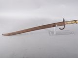 a close up of a sword on a stand on a white surface