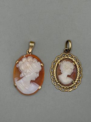 two cameo cameos of a woman and a man in profile