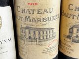 several bottles of wine are lined up on a table