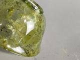 a green ring that is sitting on a white surface
