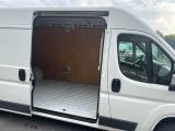 a white van with its doors open in a parking lot
