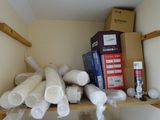 many rolls of toilet paper on a shelf in a room