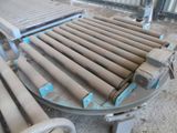 a conveyor belt that has a lot of pipes on it