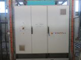 a large white refrigerator in a building with a blue sign on it
