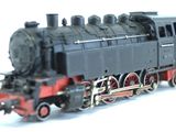 a toy train on a white surface with a white background