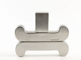 a metal object that is sitting on top of a white surface