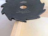 someone is using a circular saw to cut a piece of wood