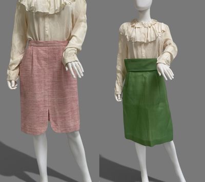 two mannequins dressed in pink and green are standing next to each other