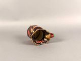 an image of a gold and red ring with a flower design