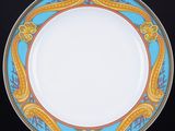 a close up of a plate on a stand with a black background