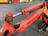 a red tractor that is parked in a parking lot