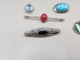 several different types of jewelry are displayed on a white surface