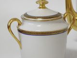 a white and gold tea pot and a gold tea pot
