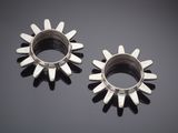 pair of silver sunbursts on a black surface