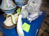 a blue table topped with vases and figurines on it