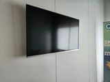 a flat screen tv mounted on a wall in a room
