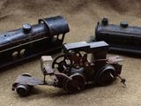 three toy trains sitting next to each other on a table
