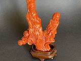 a statue of two people sitting on a wooden stand