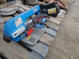 a blue machine that is sitting on a pallet