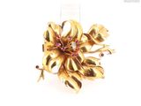 an image of a gold flower brooch with pink and white stones