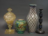 three vases and a lamp on a table
