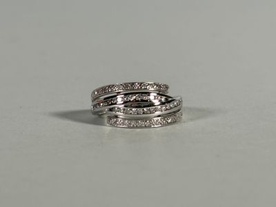 a close up of a diamond ring on a white surface