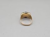 a close up of a gold ring with a diamond on it