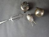 a silver spoon, a silver spoon and a silver spoon on a table