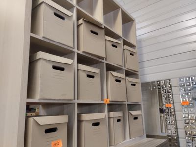 many bins on the shelves in the room