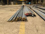 a pile of steel rods sitting in a warehouse
