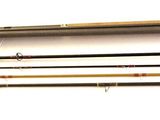 four different types of fishing rods on a white surface