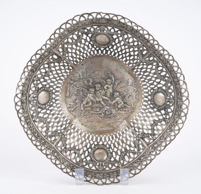 an antique silver plate with a picture of a man and a woman on it