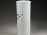 white vase with a yellow bird on the side of it