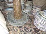 a vase that is sitting on top of a pile of plates