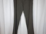 a pair of olive green pants hanging on a white curtain