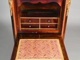 a small wooden desk with drawers and drawers on top of it