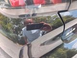 a man taking a picture of himself in the mirror of a car