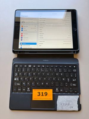 a laptop and a tablet on a table with a price tag