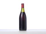 a bottle of wine sitting on top of a table next to a glass