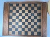 a picture of a chess board and a clock on a table