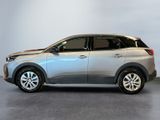 the silver car is parked in a room with a white wall