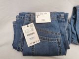 a pair of jeans with a price tag on them