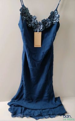 blue dress hanging on a hanger with a tag on it