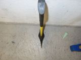 a hammer stuck in the corner of a room
