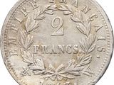 a close up of a coin with a wreath on it
