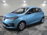 a blue car is parked in a room with a checkered floor