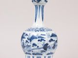 a blue and white vase sitting on a white surface