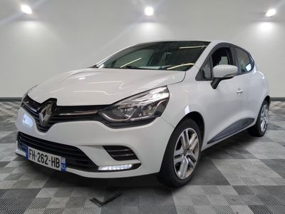 the white car is parked on a checkered tile floor