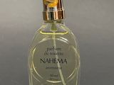 two bottles of perfume sitting next to each other on a table